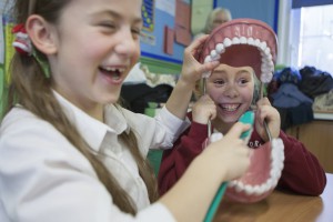 A group of dental students visit a local Primary School to demonstrate oral hygiene to the pupils.