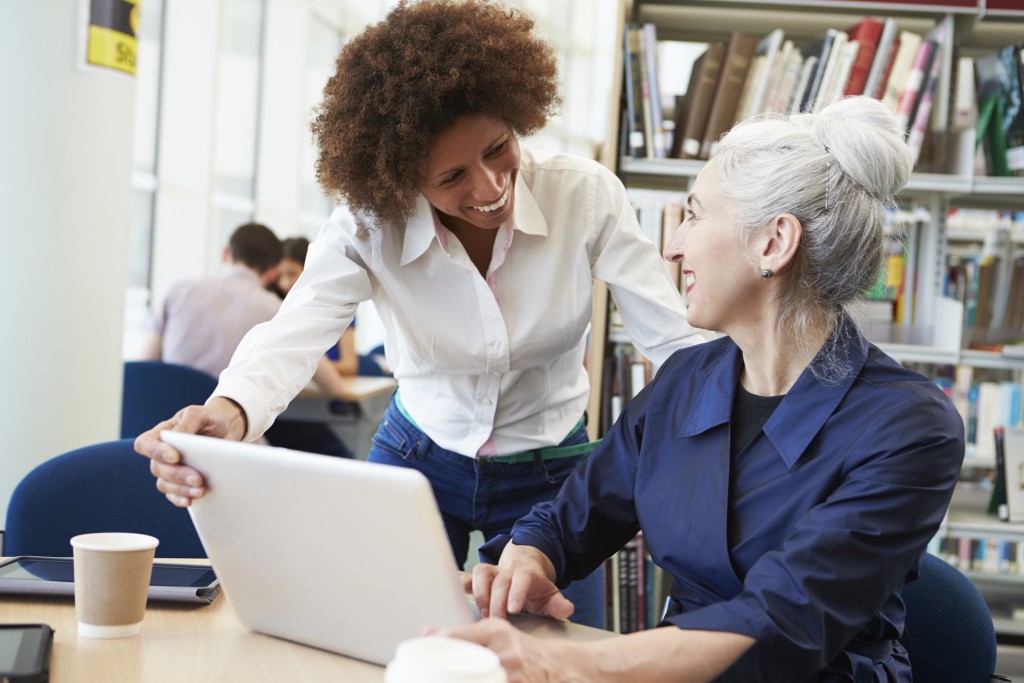 Mature students using laptop to help with studying stock photo